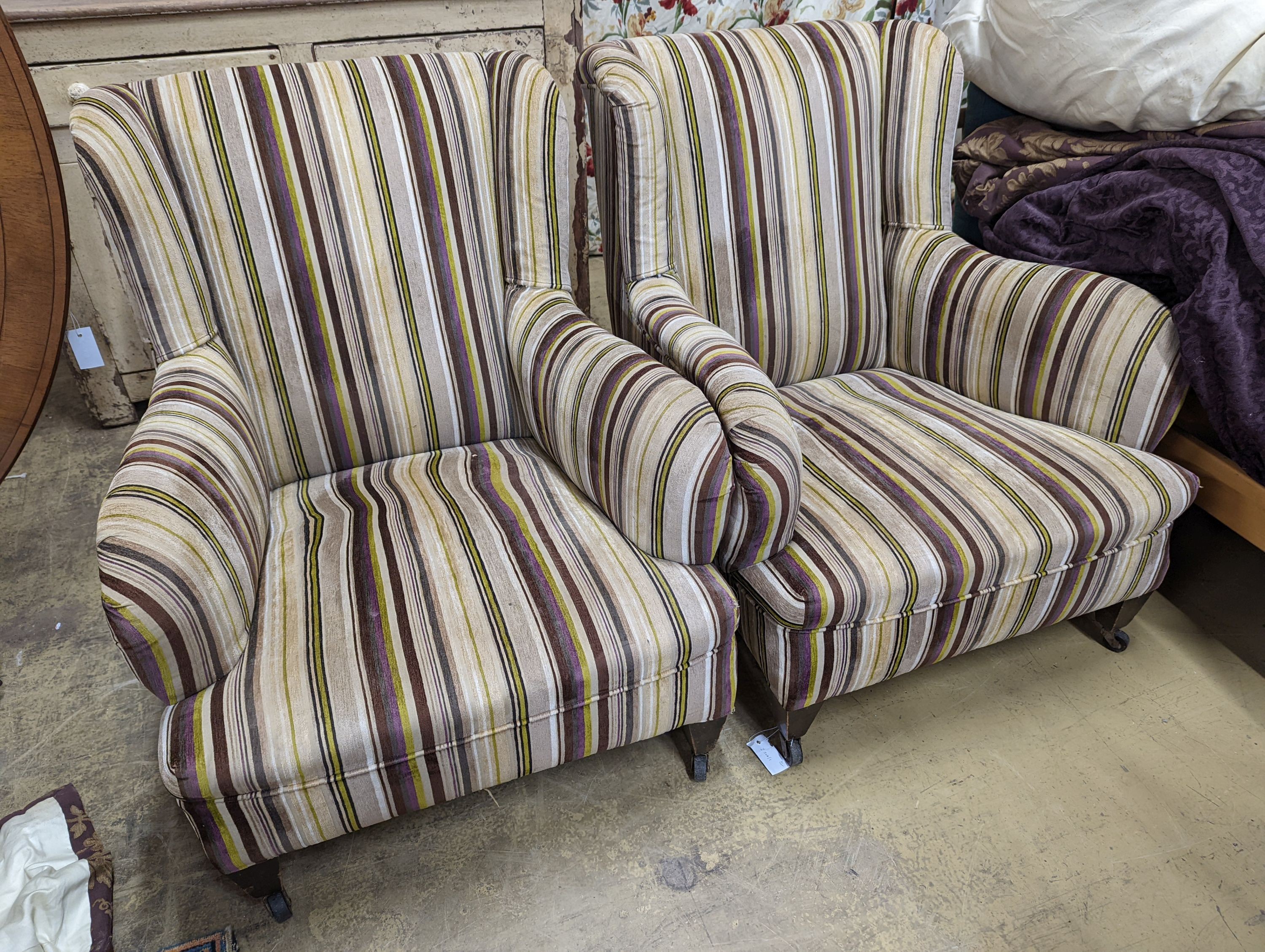 A pair of late Victorian Howard & Sons style armchairs, recently re-upholstered in a contemporary striped fabric, width 76cm, depth 88cm, height 87cm